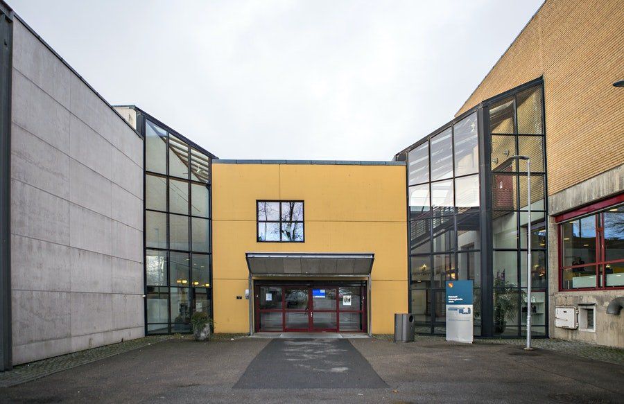 A large yellow building with a lot of windows