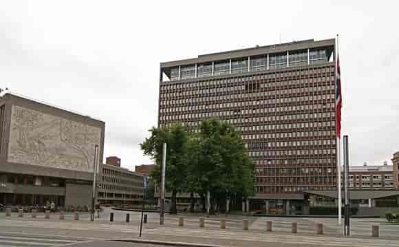 A large building with a flag flying in front of it.
