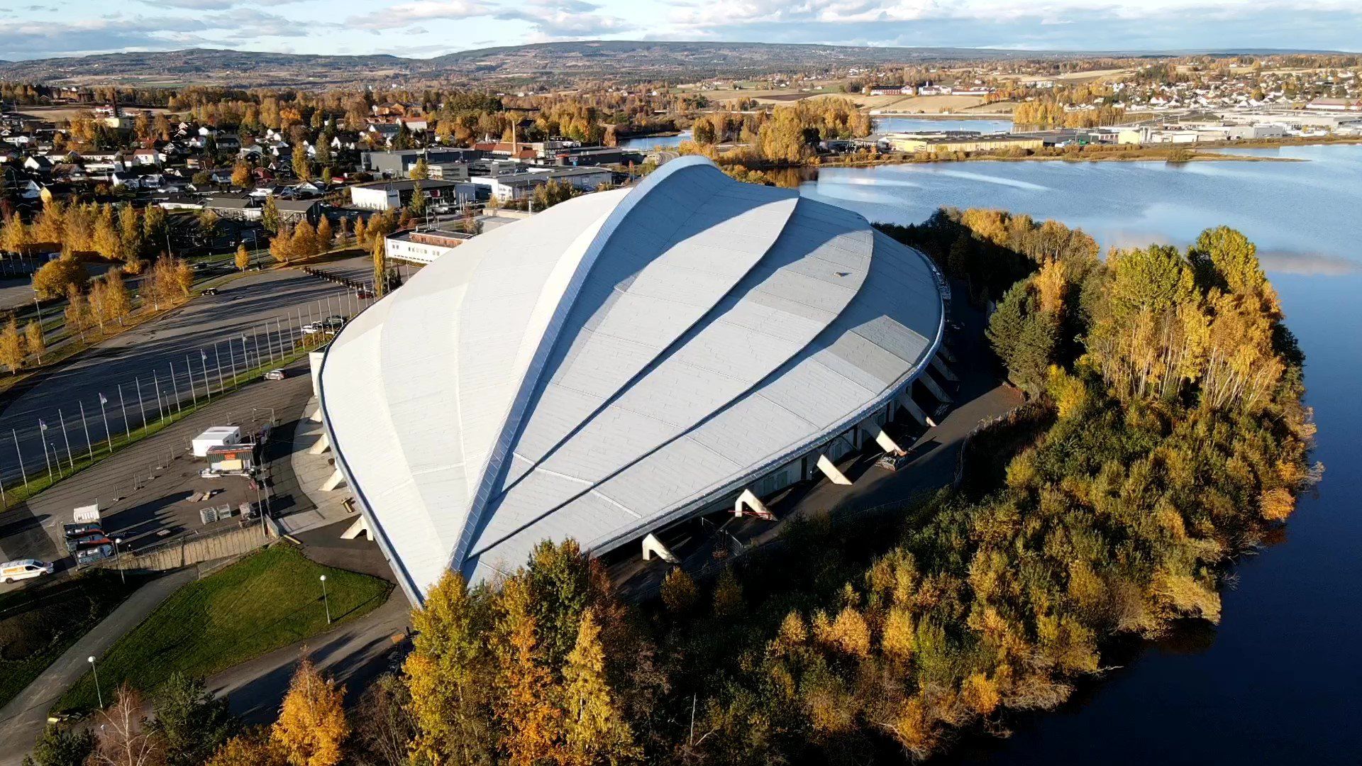 An aerial view of a large building sitting on top of a small island in the middle of a body of water.