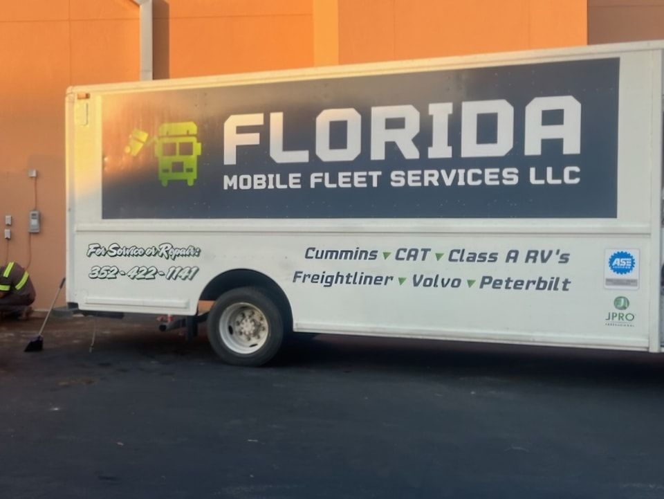 A florida mobile fleet services llc truck is parked in front of a building