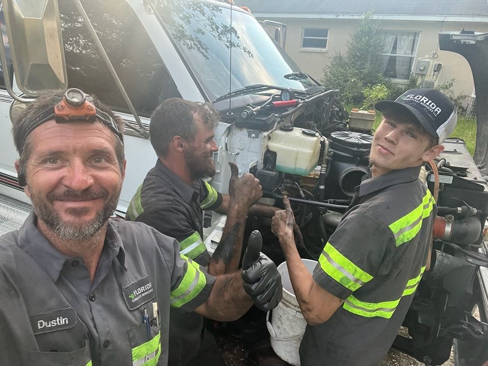 A group of men are working on a truck.