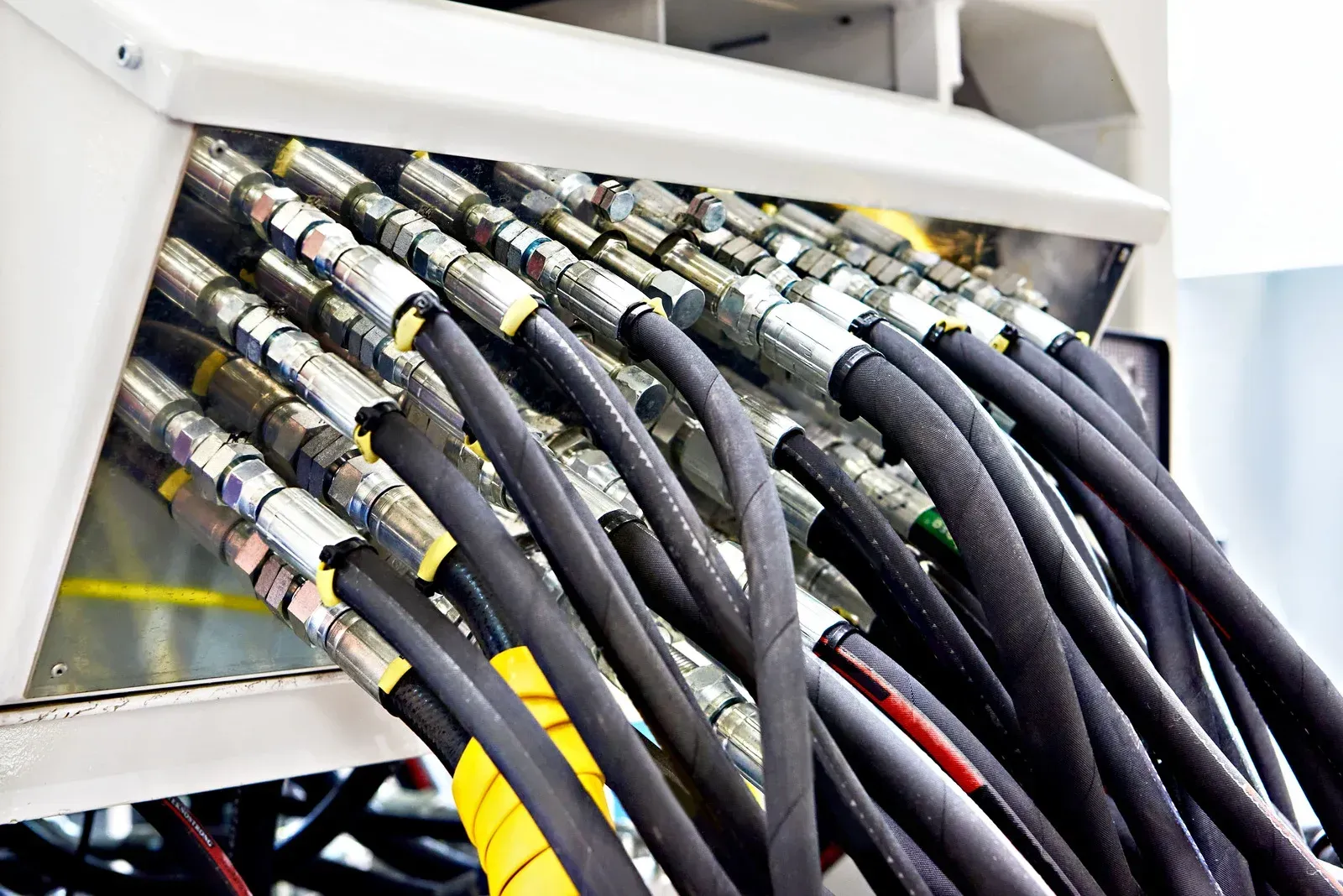 A bunch of hydraulic hoses are stacked on top of each other.