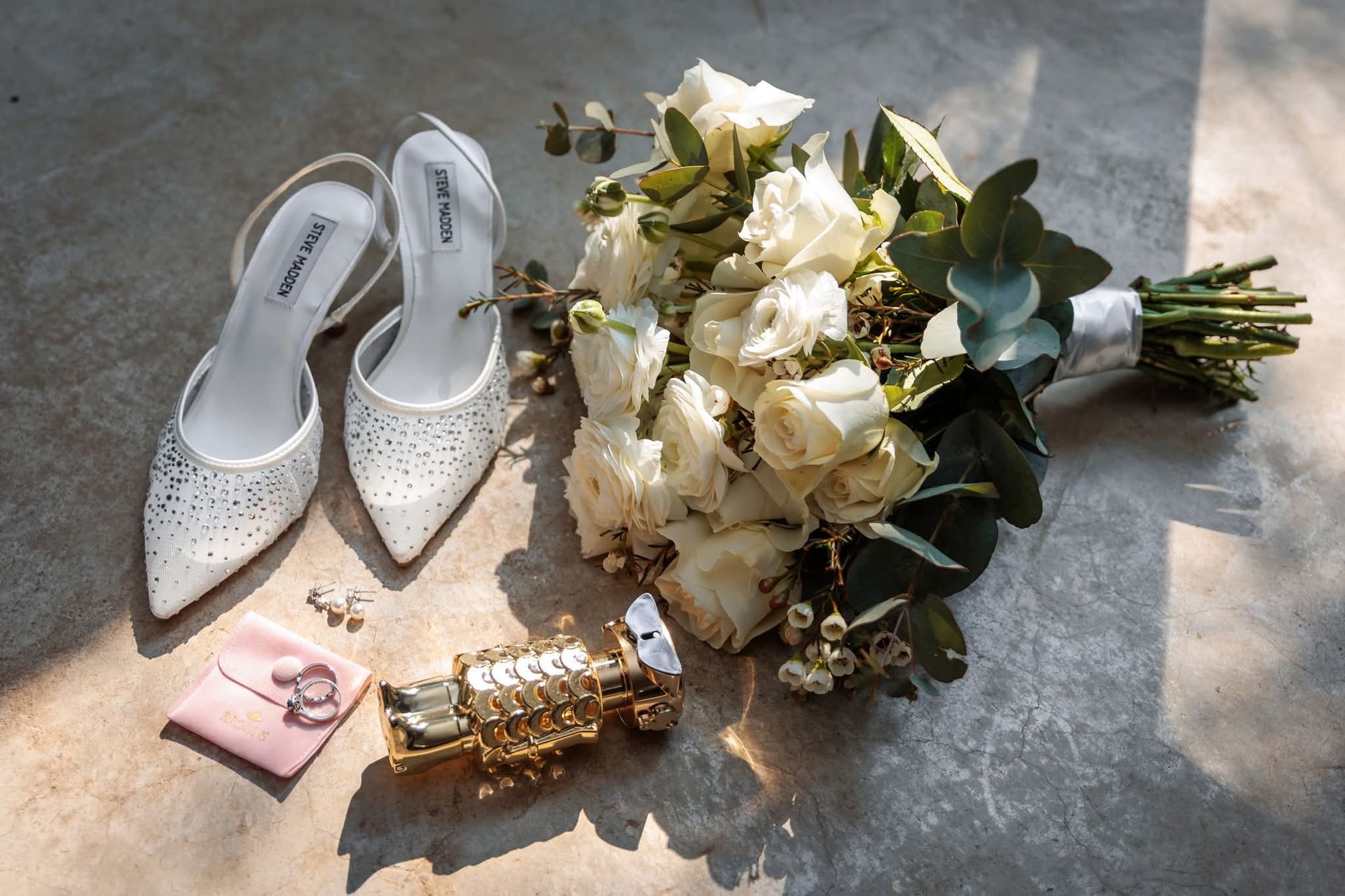 Bridal shoes and flower bouquet at Riverside Castle wedding venue.