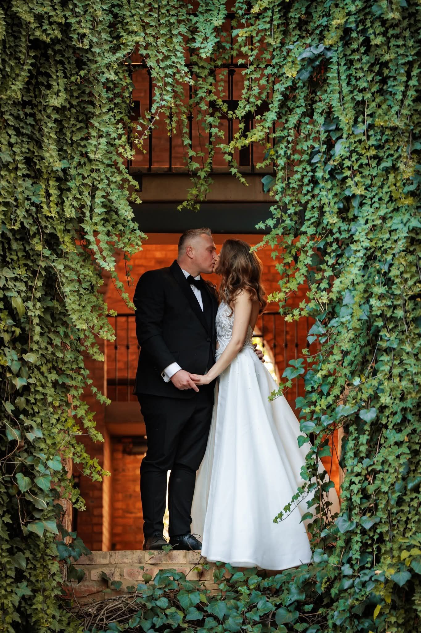 A couple kissing after their wedding ceremony at Riverside Castle wedding venue.