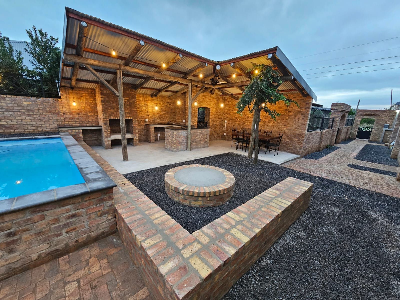 The fire pit and outdoor dining area near the sleek and modern new cottages at Riverside Castle in Pretoria.