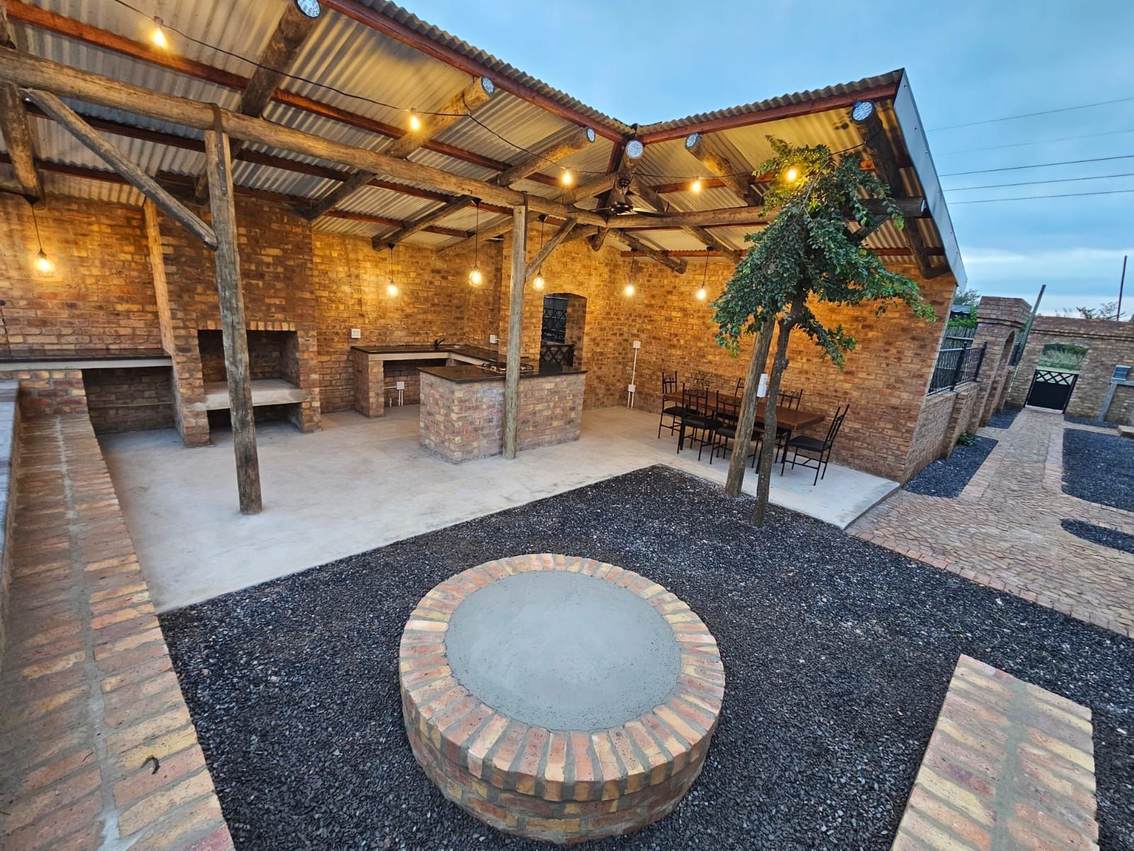 The fire pit and outdoor dining area near the sleek and modern new cottages at Riverside Castle in Pretoria.