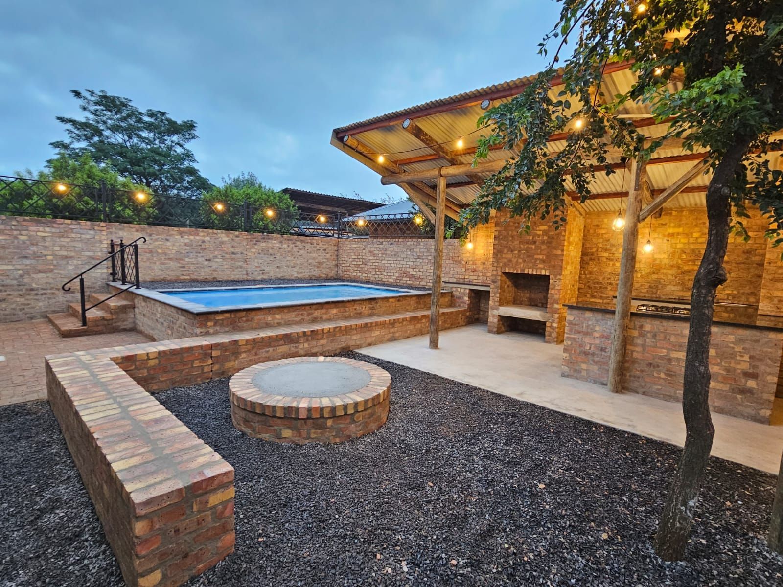 The fire pit and outdoor dining area near the sleek and modern new cottages at Riverside Castle in Pretoria.