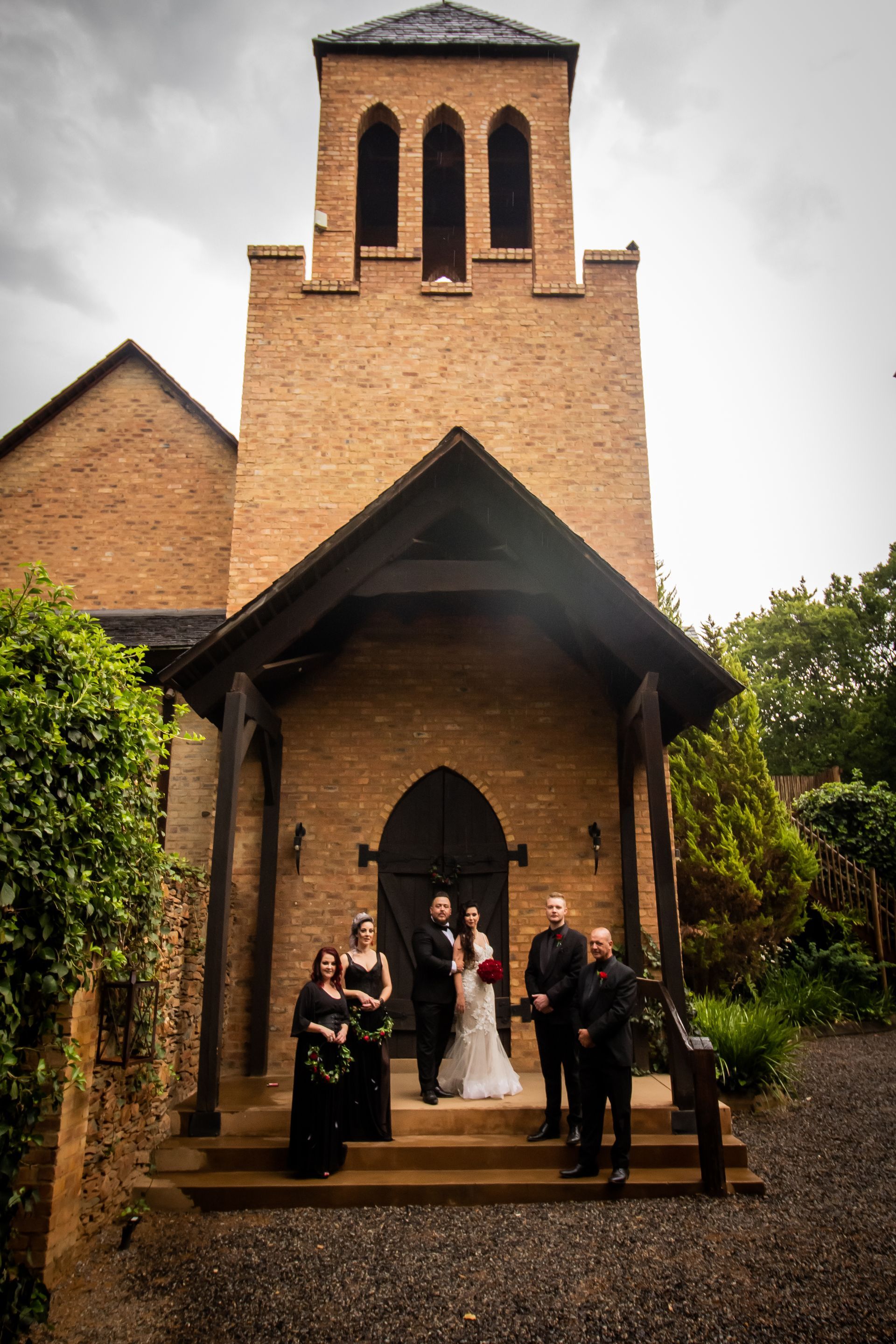 A bride and groom are posing for a picture in front of the chapel at Riverside Castle, Gauteng's premier wedding venue.