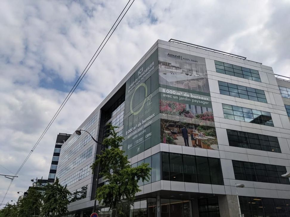 A large building with a large advertisement on the side of it.