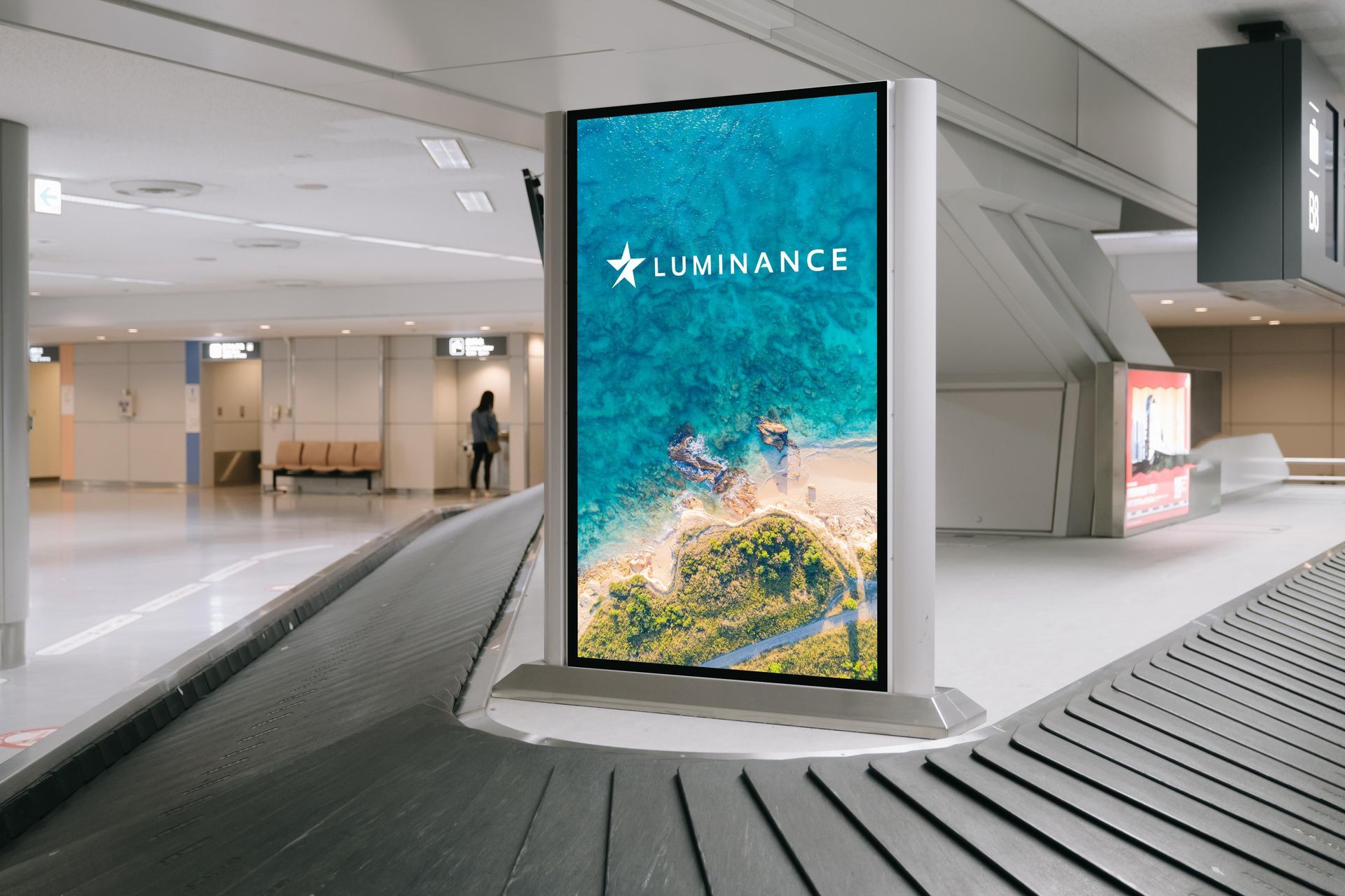 A large billboard is sitting on a conveyor belt in an airport.