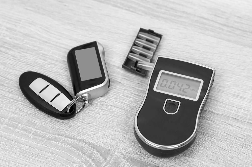 Car Key Fob and a Breathalyzer Displaying a Reading of 0.042 — Paradise Law In Surfers Paradise, QLD
