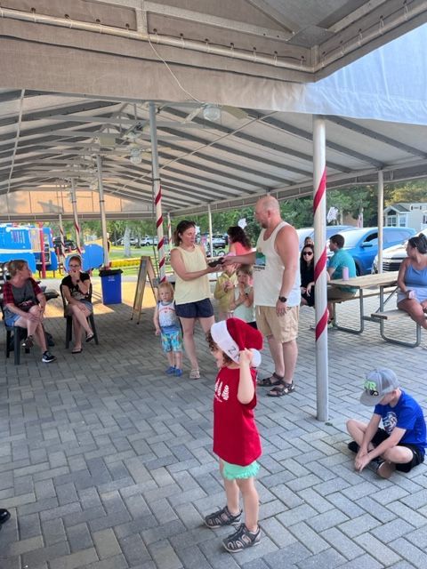 A little boy wearing a red shirt that says ' ny ' on it