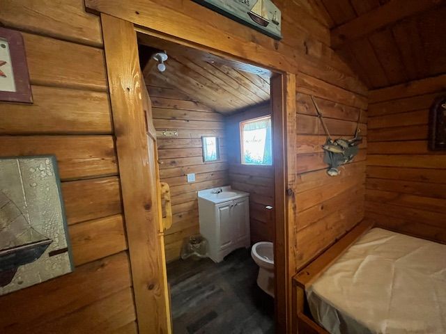 Wood-paneled cabin bedroom with bunk beds, a single bed, and a door at the far end