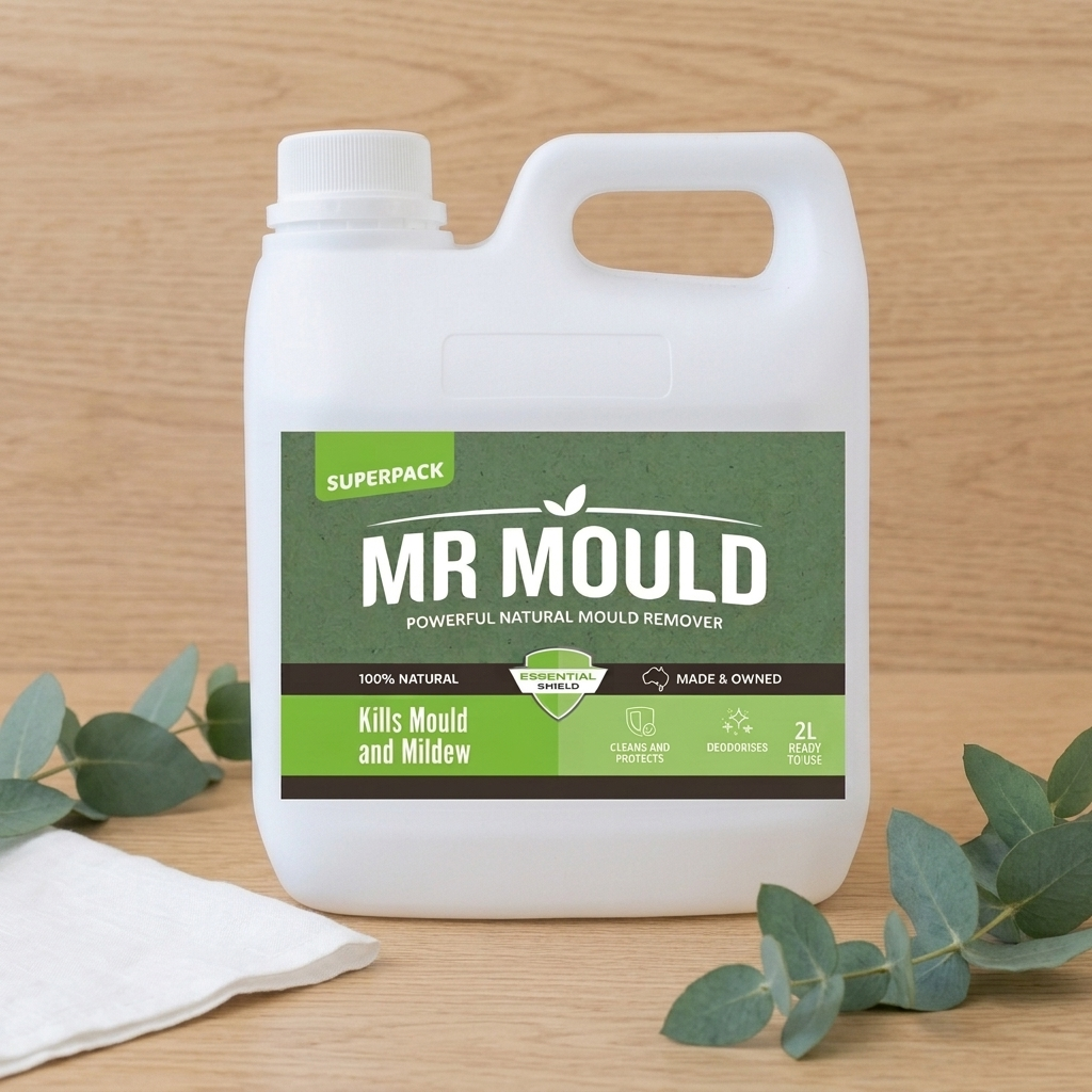 White Mr Mould cleaning liquid bottle with green label on a wooden surface, beside a cloth and eucalyptus leaves