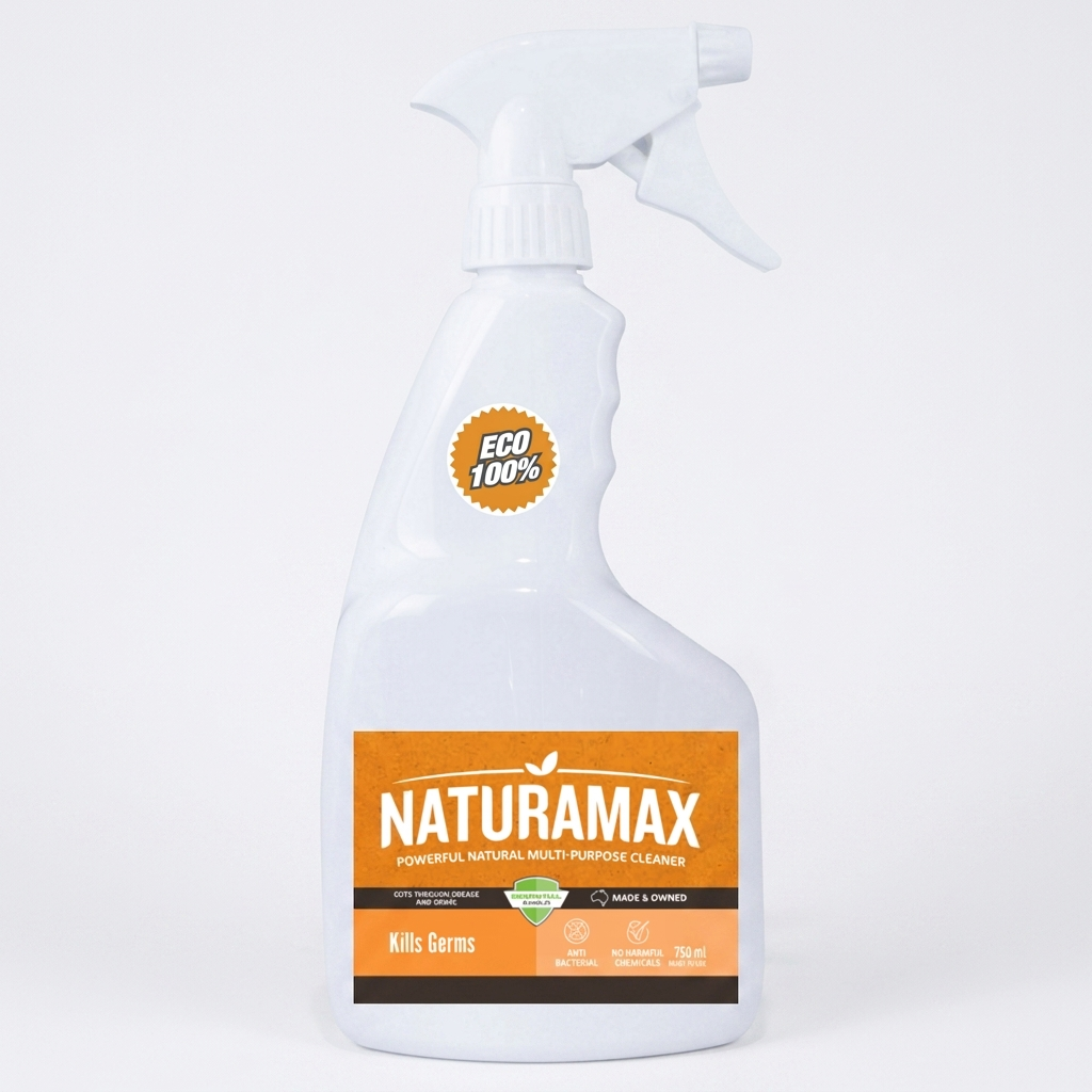 White Naturamax spray bottle on a gray surface with a cloth and green leaves nearby