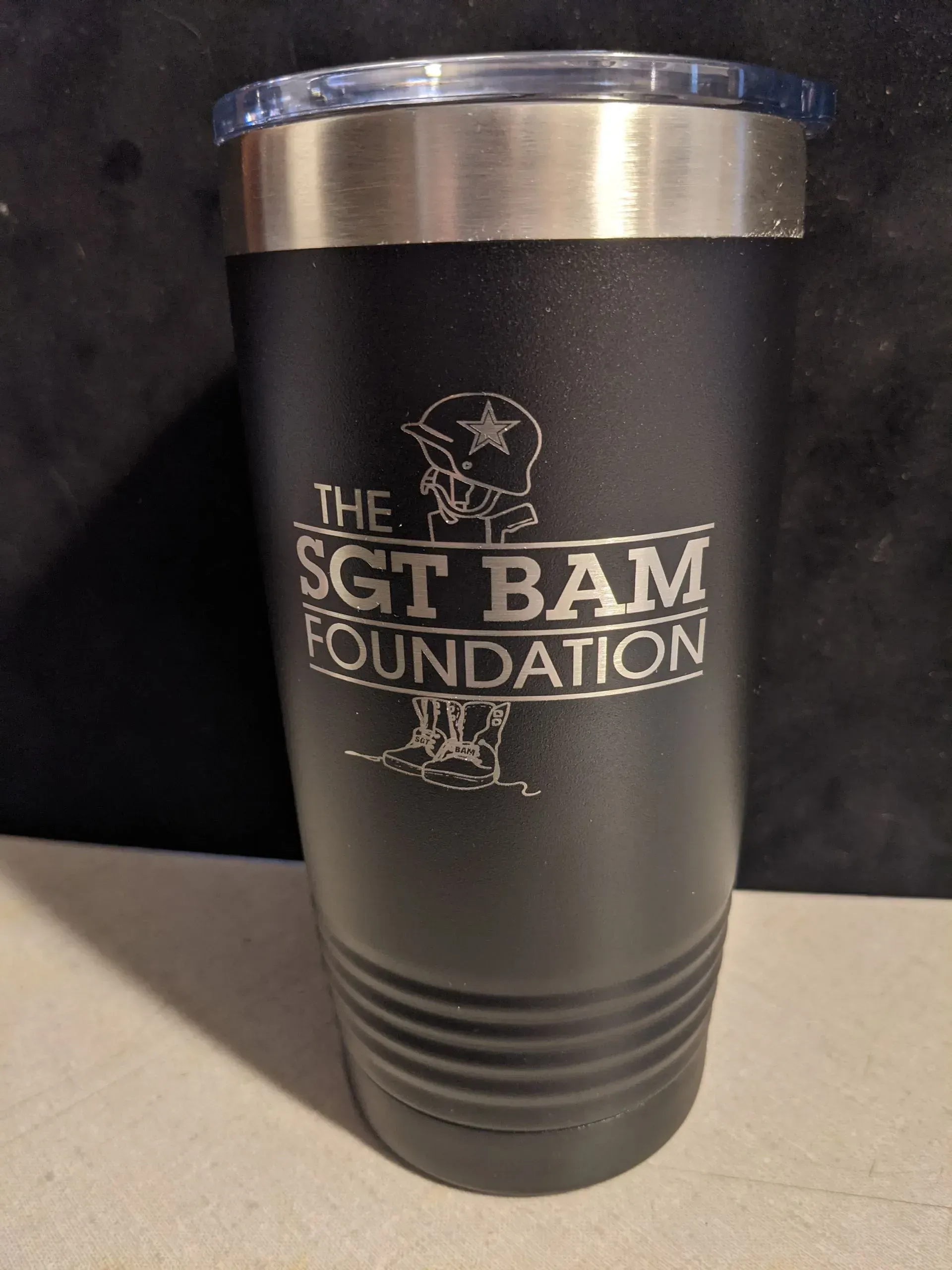 A laser engraved in black tumbler.
