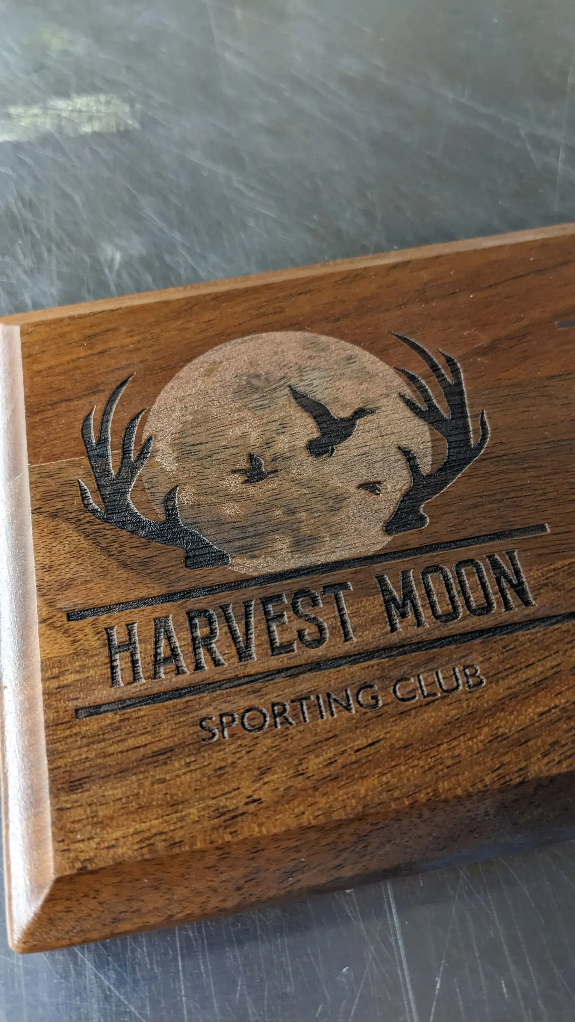 A wooden box with a harvest moon logo on it is sitting on a table.