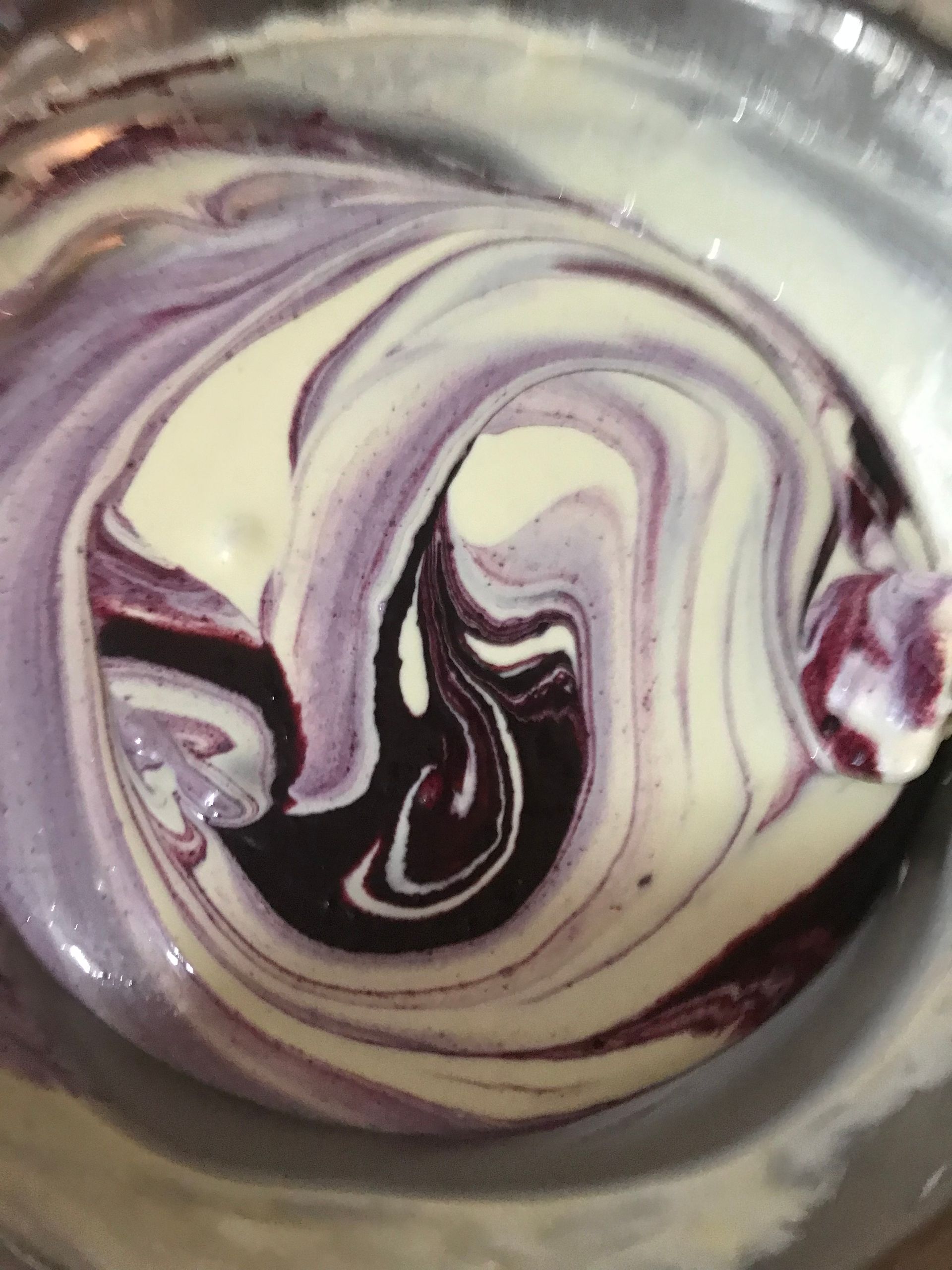 Swirled purple, cream, and dark brown marbled candy close-up