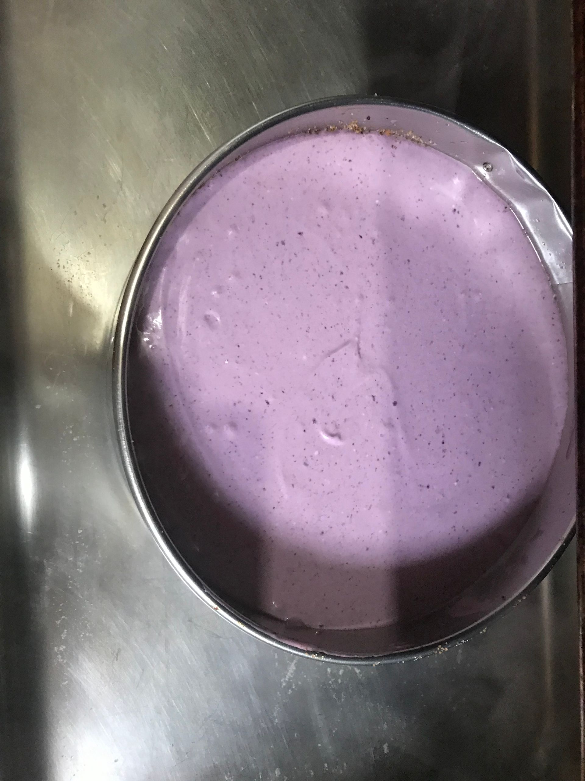 Purple liquid in a stainless steel bowl viewed from above