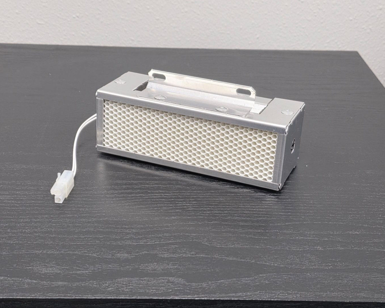 A UV-powered catalytic cartridge that creates oxidizing molecules to actively break down contaminants in the air and on surfaces