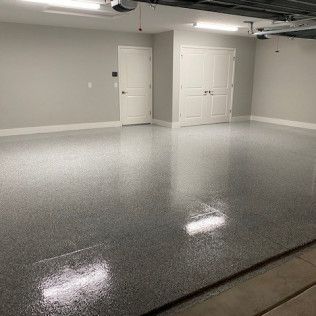 A garage with a shiny floor and white doors.