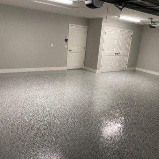 A garage with a gray floor and white walls.