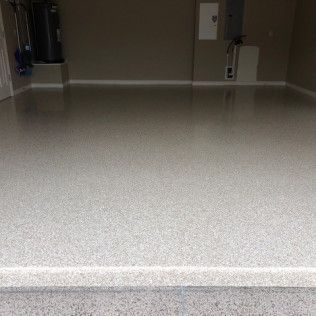 A garage with a concrete floor and a water heater.