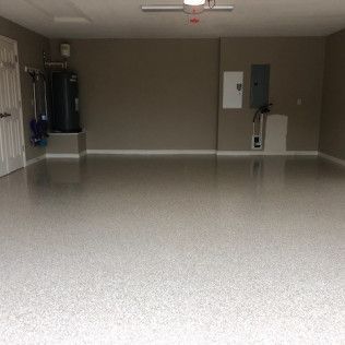 A garage with a concrete floor and a ceiling fan.