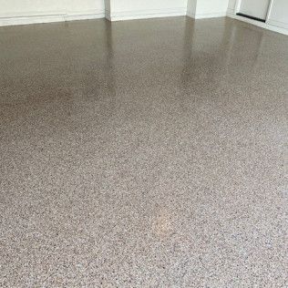 A close up of a shiny concrete floor in a room.