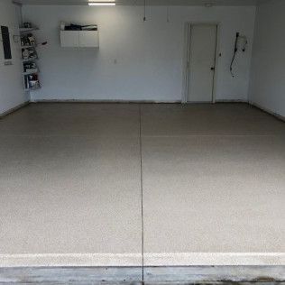 A garage with a concrete floor and white walls