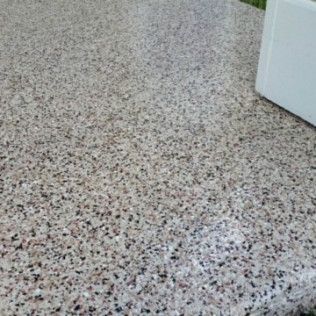 A close up of a concrete floor with a white box in the background.