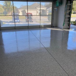 A garage with a sliding glass door and a ladder.