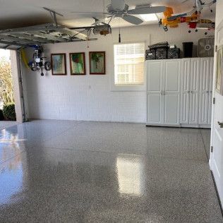 A garage with a ceiling fan and a plane on the wall