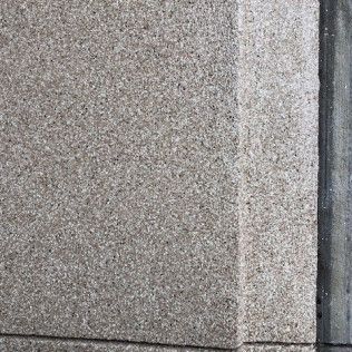 A close up of a granite wall with a corner.