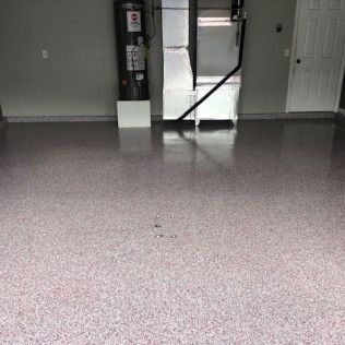 A garage with a concrete floor and a heater.