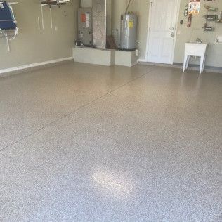 A garage with a concrete floor and a water heater.