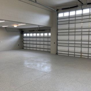 A large empty garage with a large garage door.