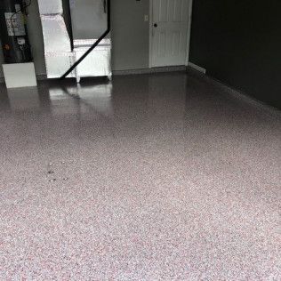 A garage with a concrete floor and a door.