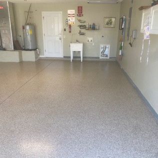 A garage with a concrete floor and a sink.
