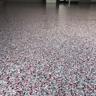 A close up of a garage floor with a lot of small stones on it.