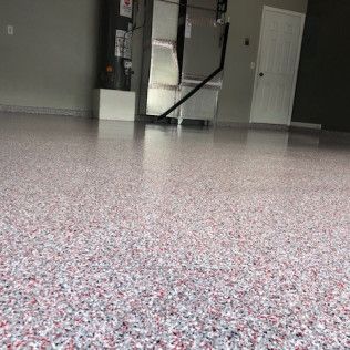Interior room with white speckled flooring, dark walls, a mirror, and two white doors.
