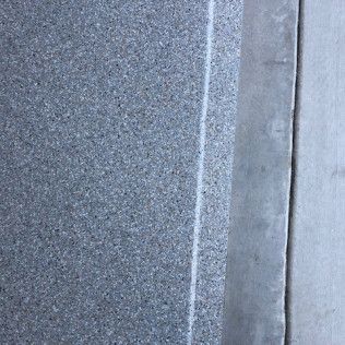 A close up of a gray granite counter top