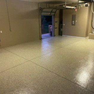 A garage with a concrete floor and a garage door.