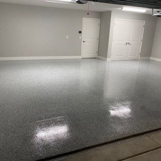 A garage with a gray floor and white walls.