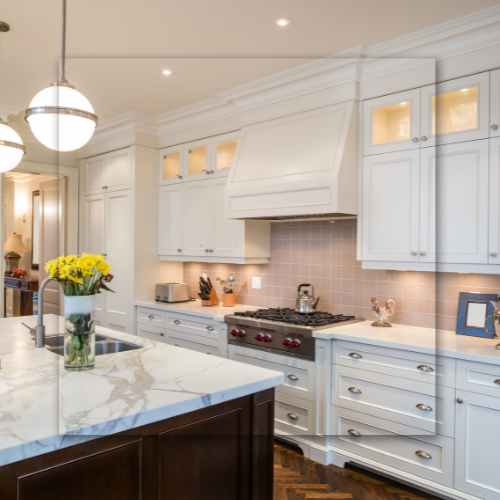 A kitchen with white cabinets and a stove top oven