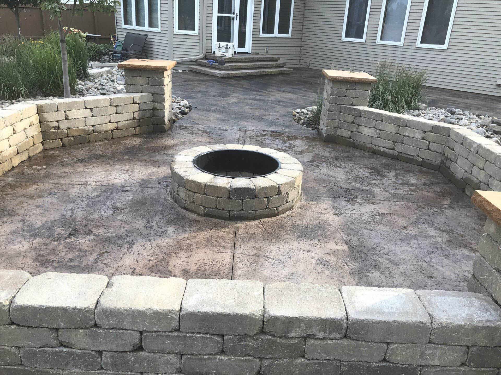 There is a fire pit in the middle of the patio.