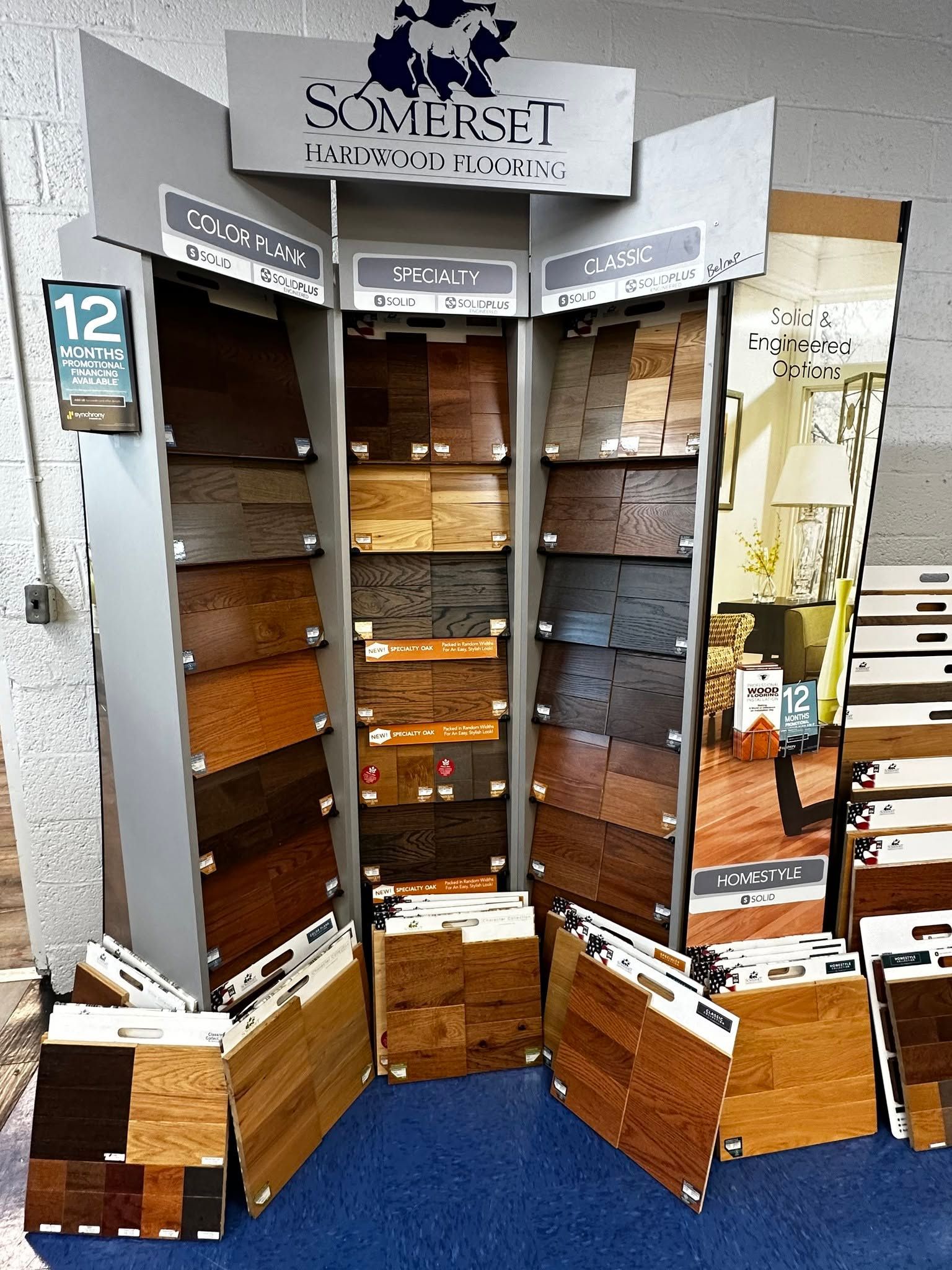 Open wooden display cabinet with shelves and drawers, showing a sign and items inside a retail setting