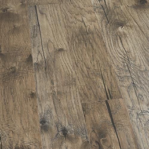 Close-up of weathered brown wooden floorboards with visible grain and knots