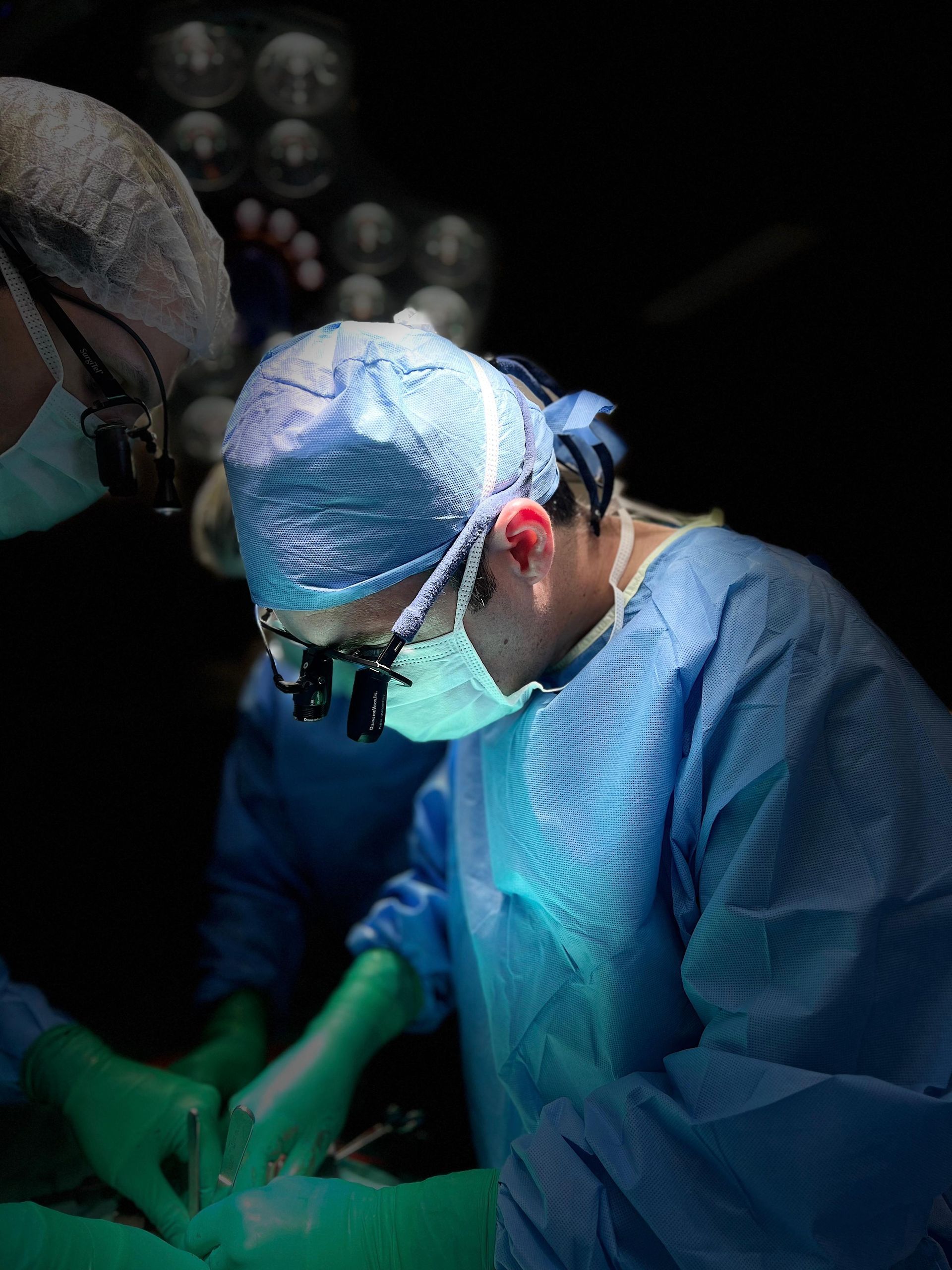 Dois cirurgiões estão operando um paciente em uma sala de cirurgia.
