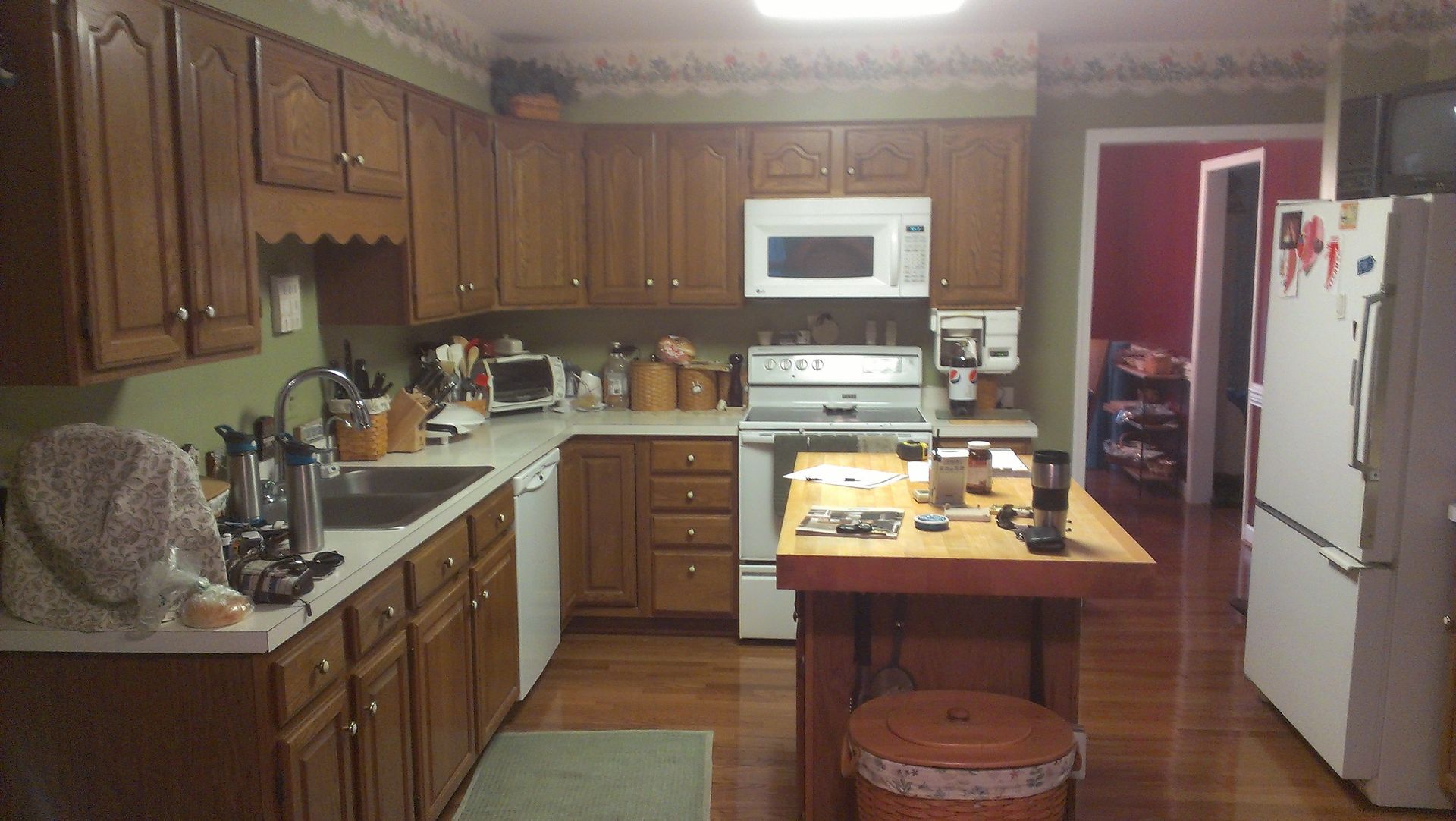 A kitchen with wooden cabinets and white appliances
